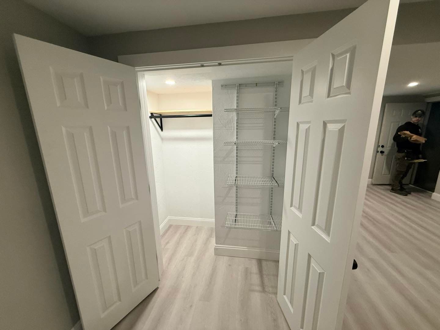 Finished basement with built-in closet and white doors