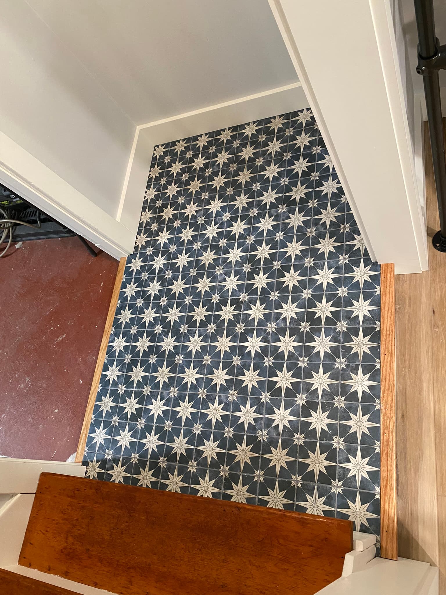 Star-pattern navy and white tile at basement entry