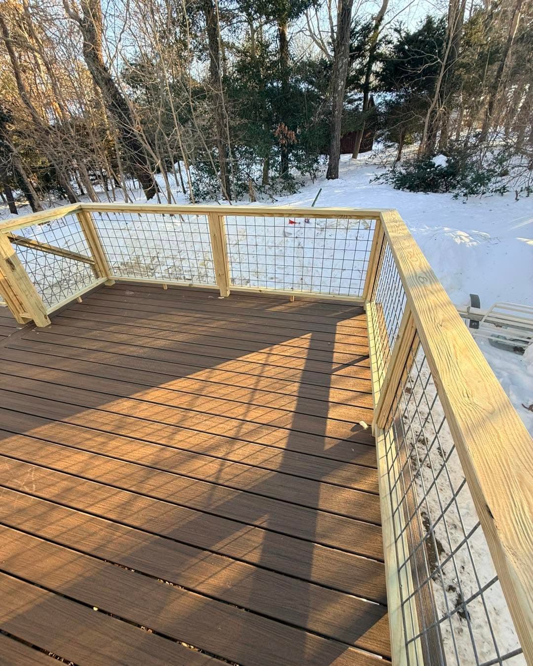 Wide view of composite decking with wood-framed cable railing