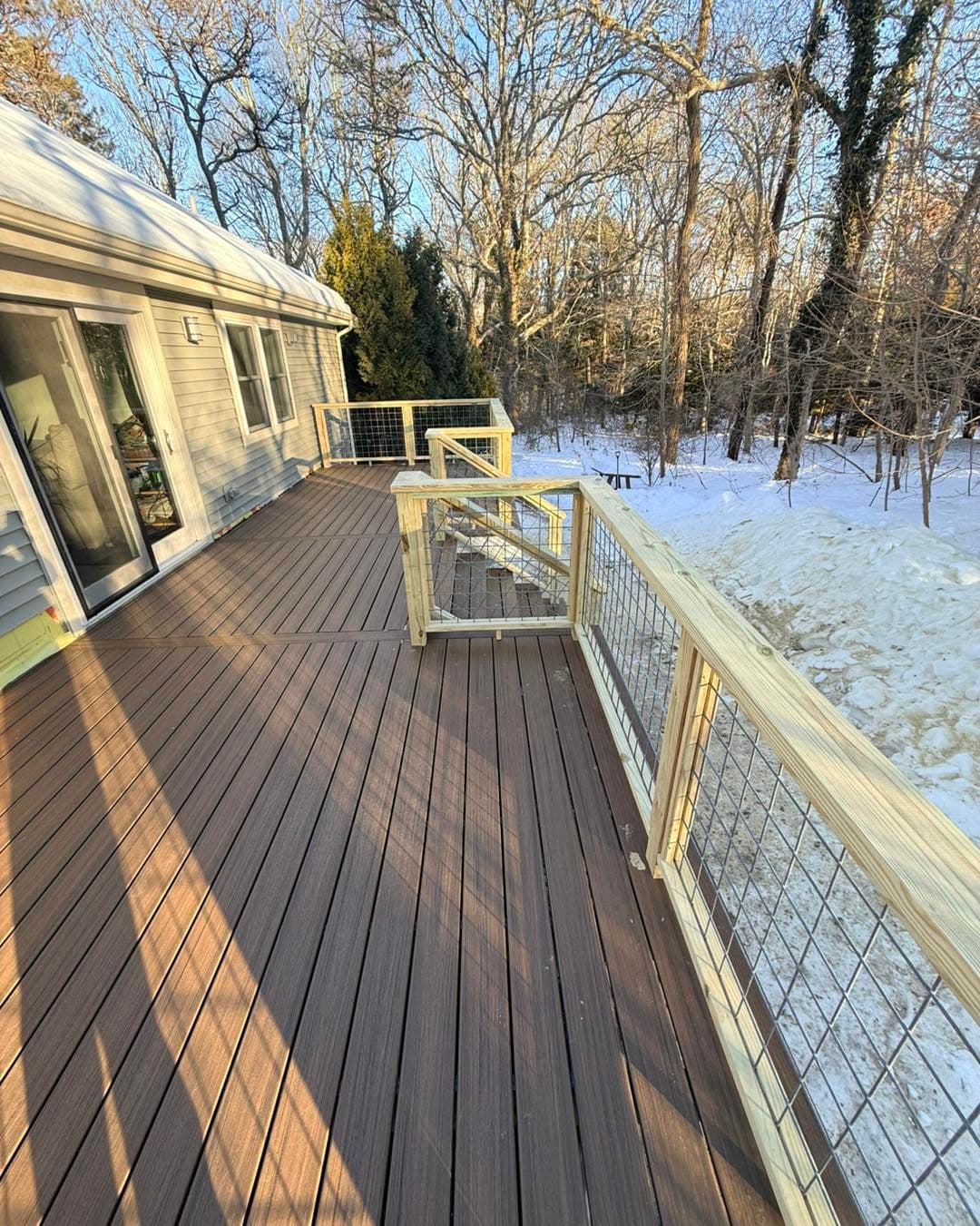 Composite deck with wood-framed cable railing