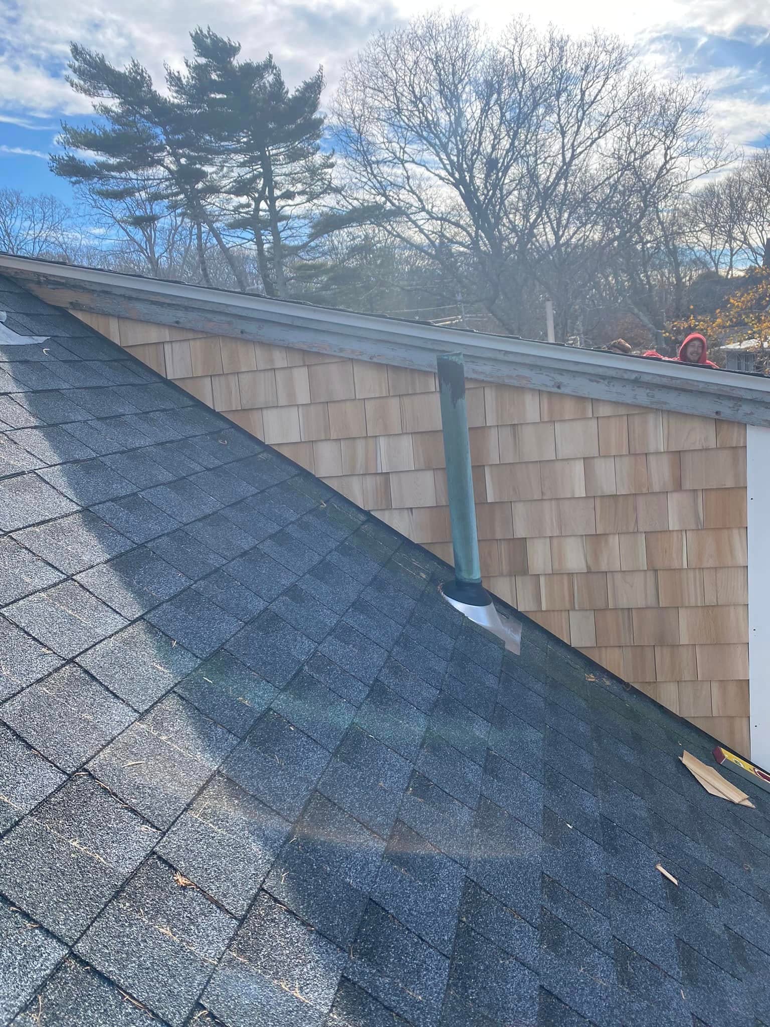 Cedar shingle siding wall with new roof
