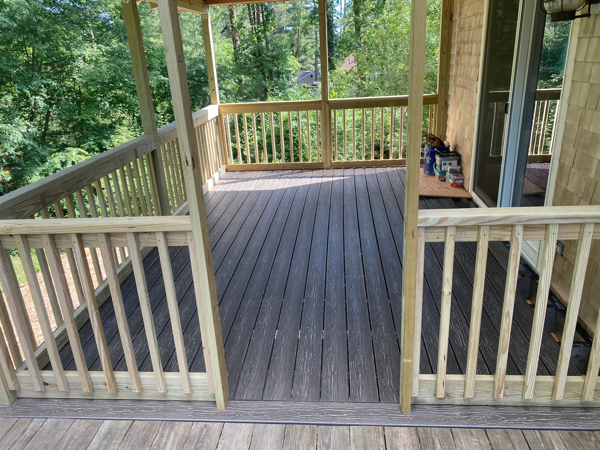 Finished covered porch with composite decking and railings