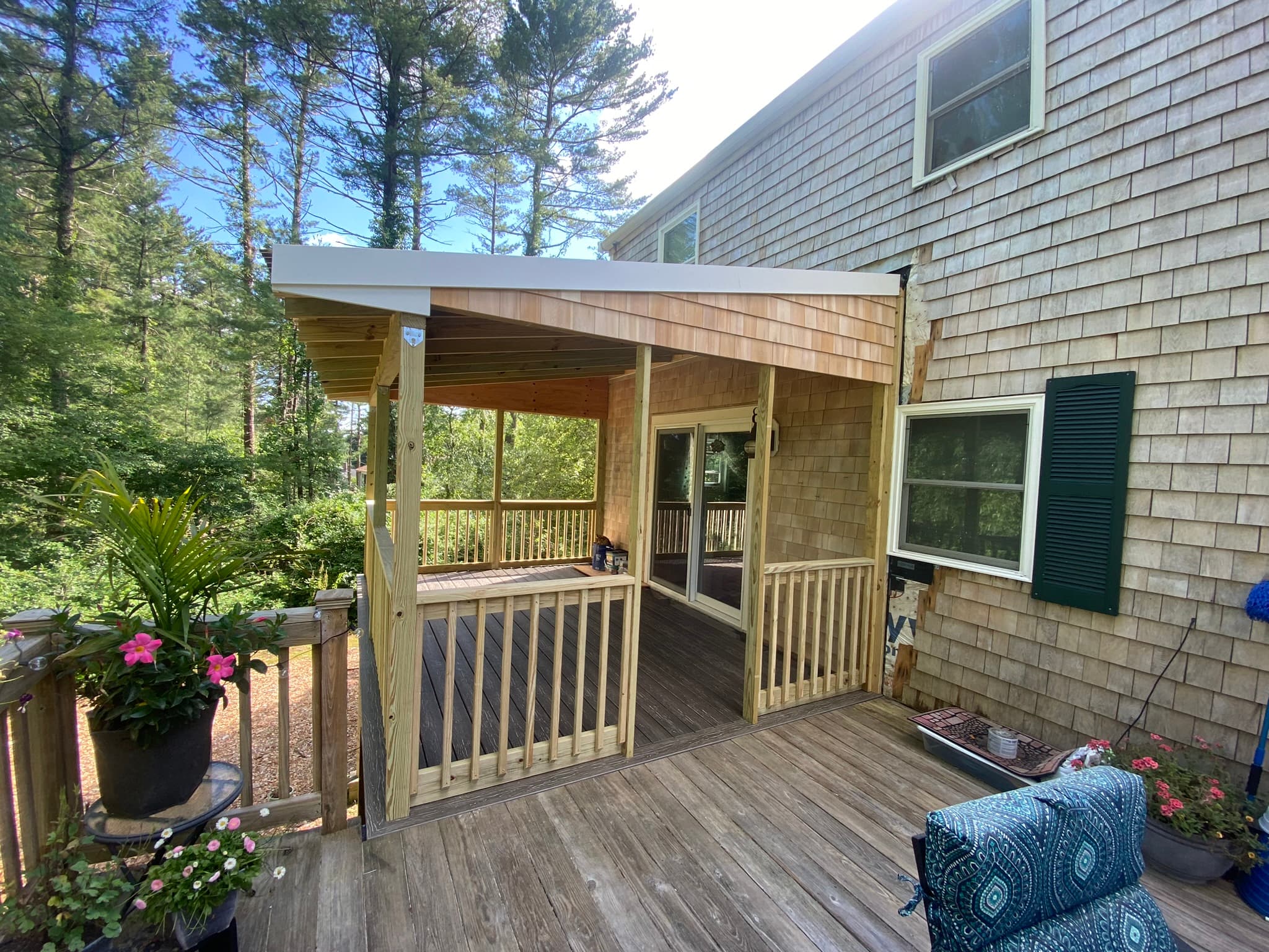 Covered porch exterior with landscaping and flowers
