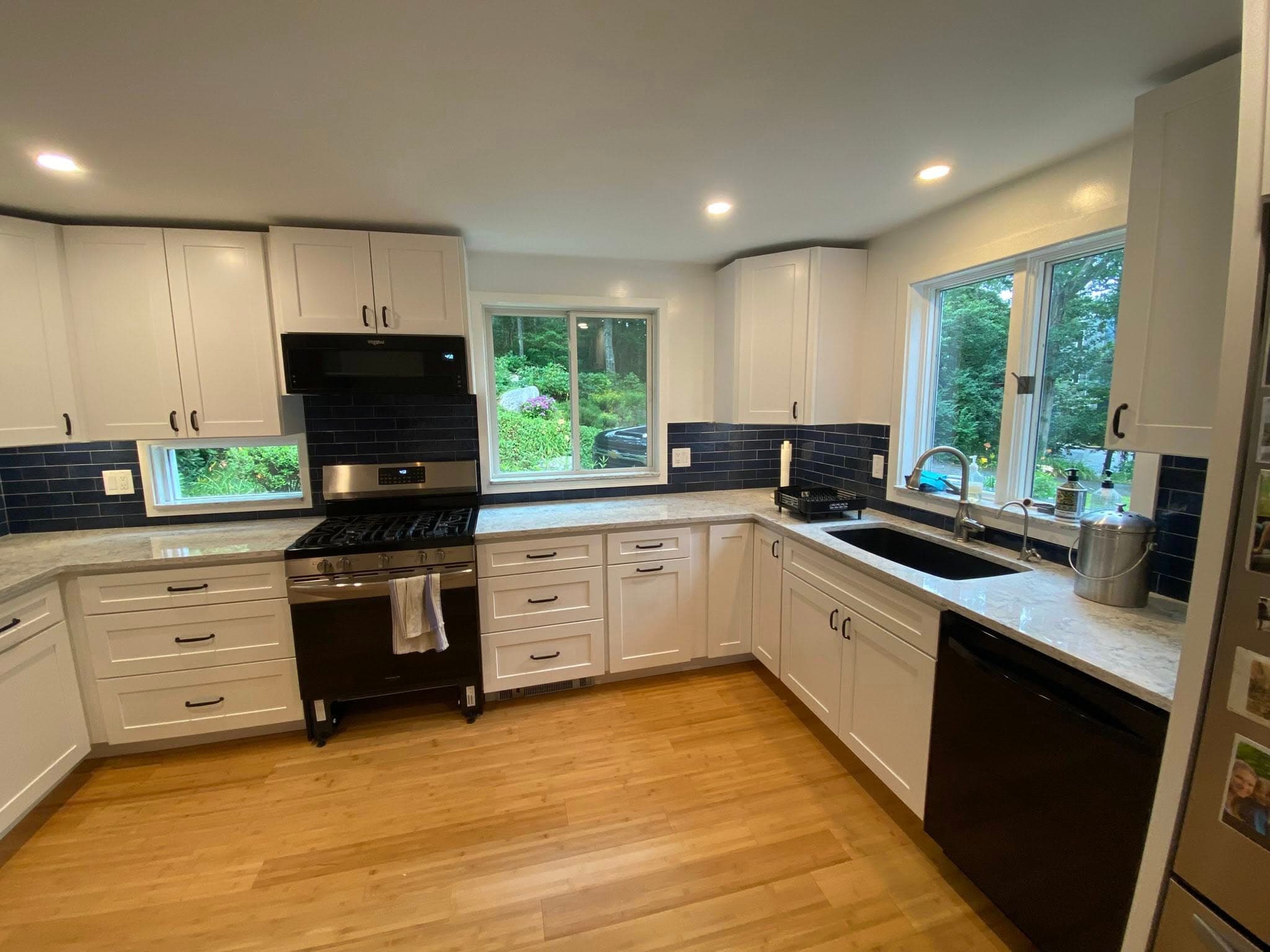 Remodeled kitchen with cream cabinetry and stone counters