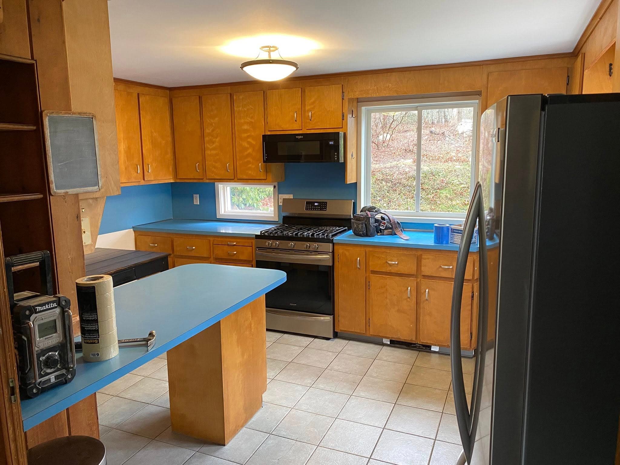 Dated kitchen with oak cabinets and laminate counters