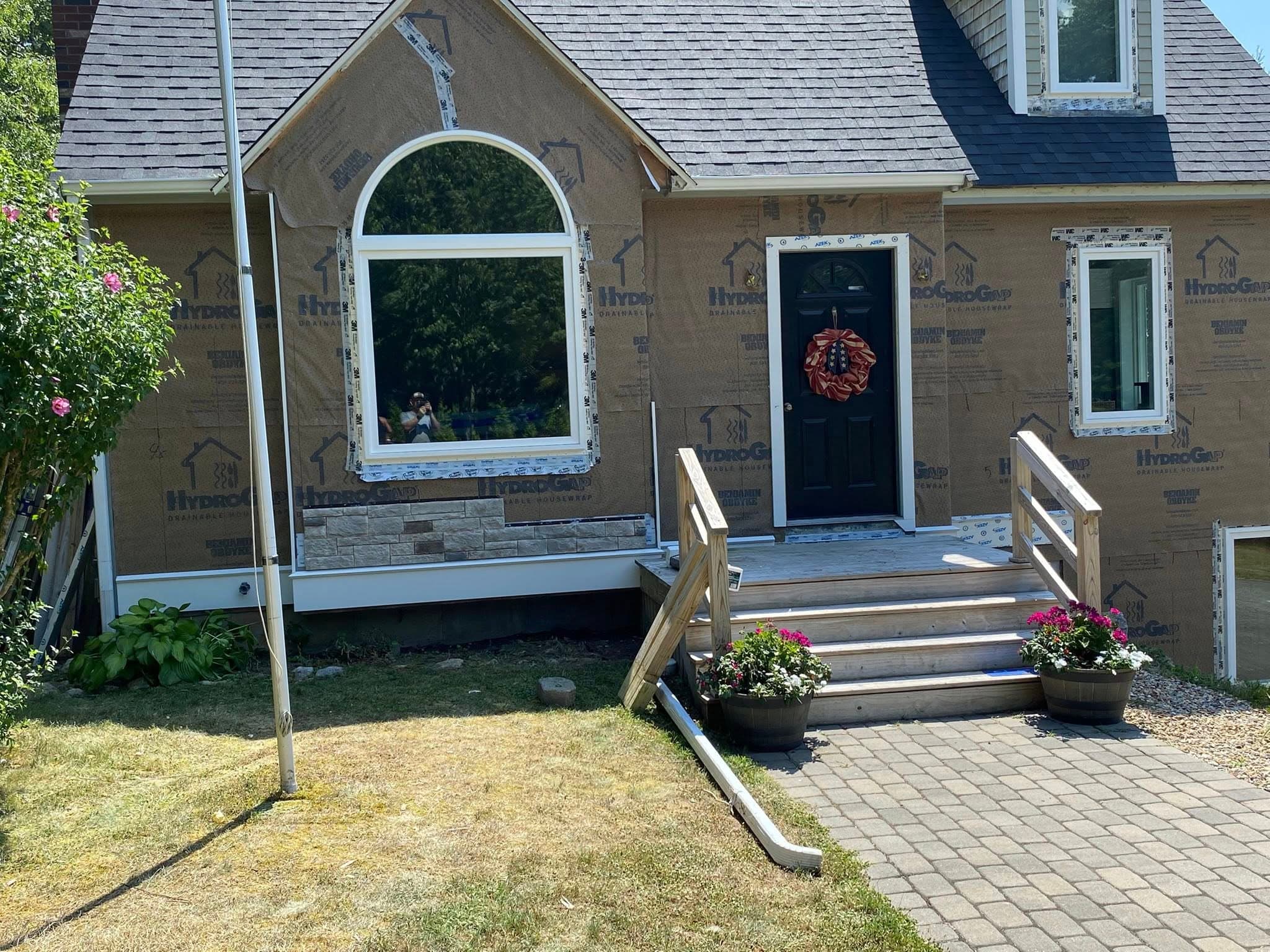 Navy home entry with arched window and stone surround