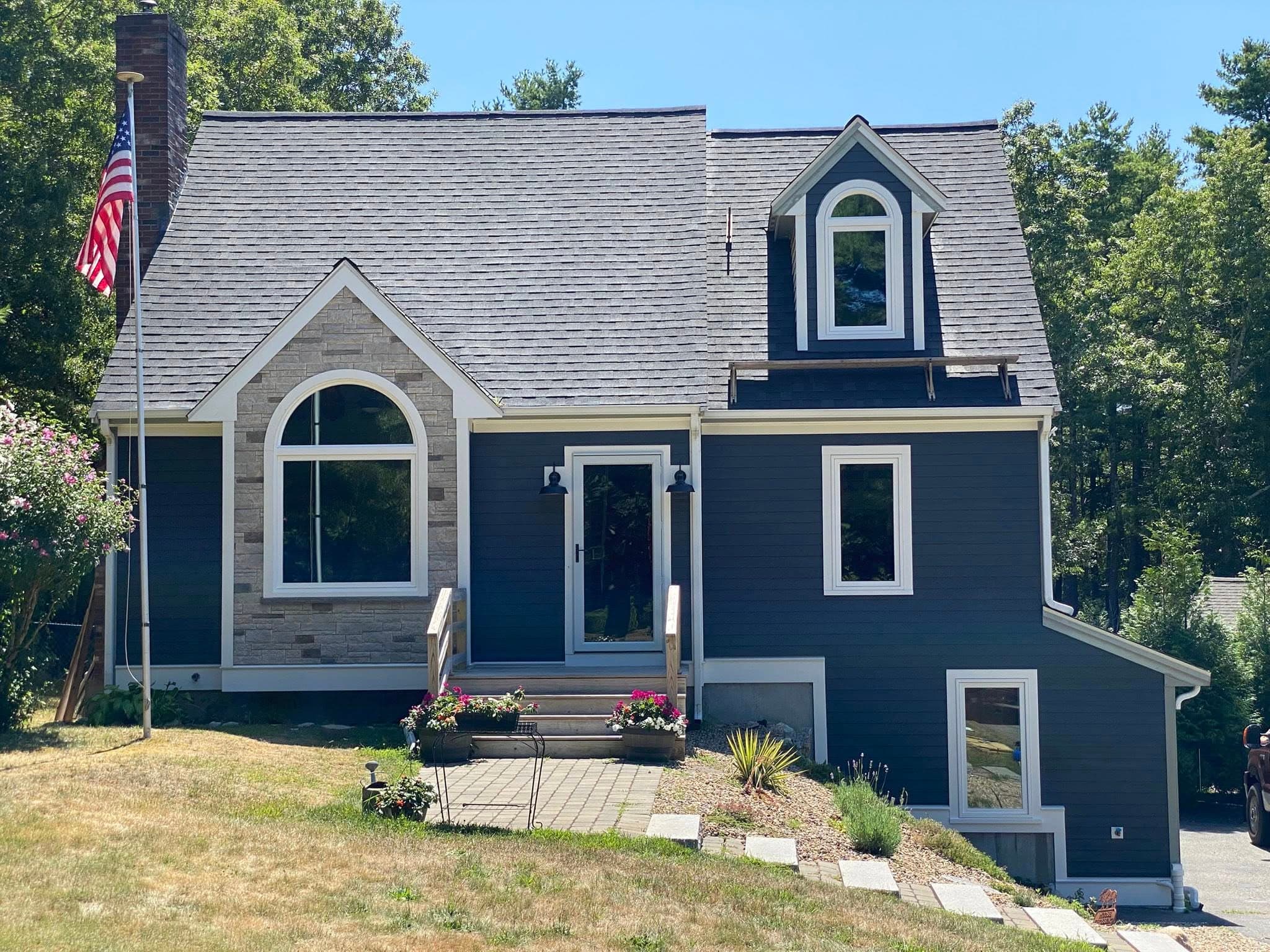 Hill Home Renovations — finished home exterior with custom composite entry stairs and white railings