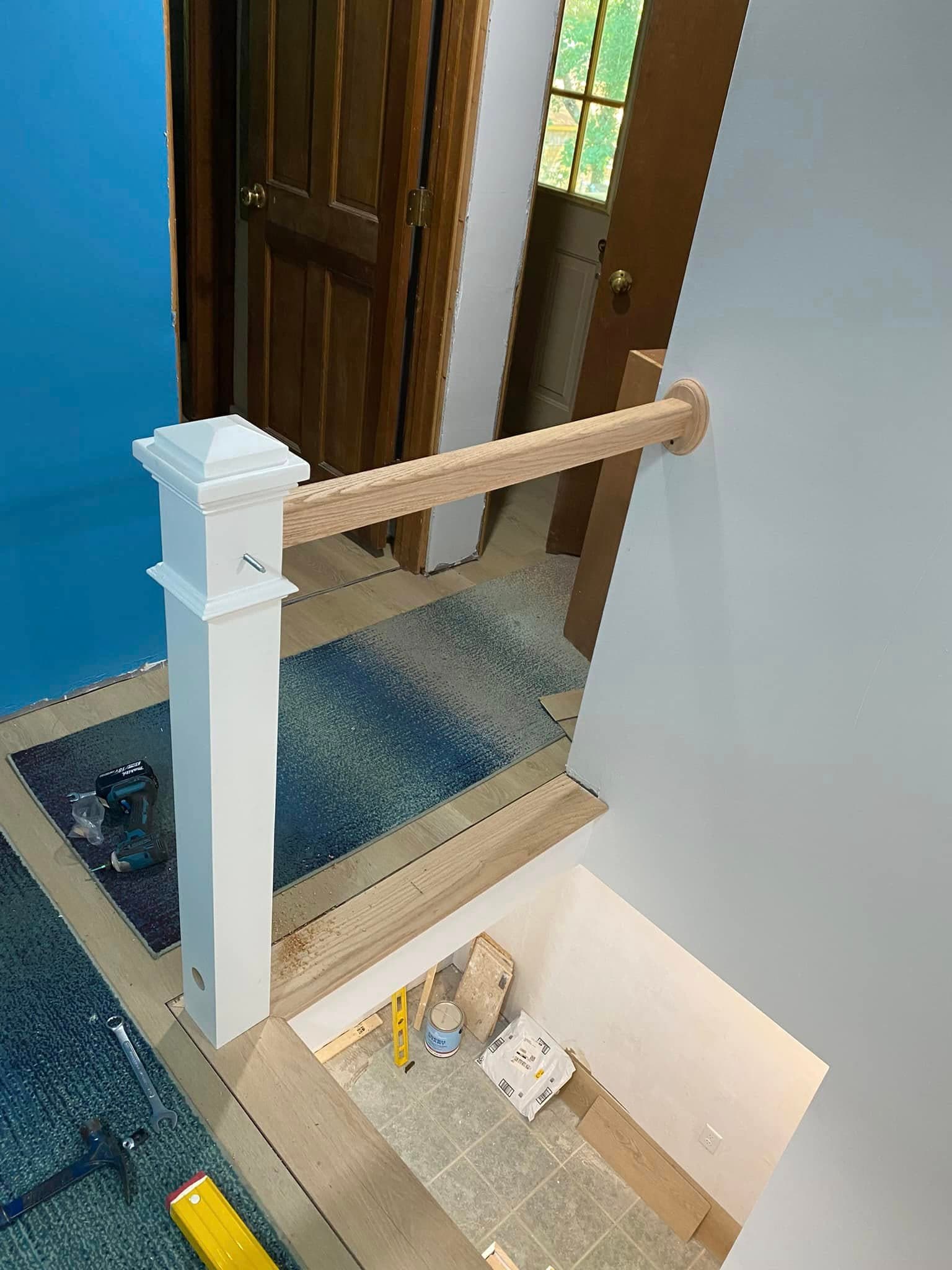 Staircase newel post and railing during installation