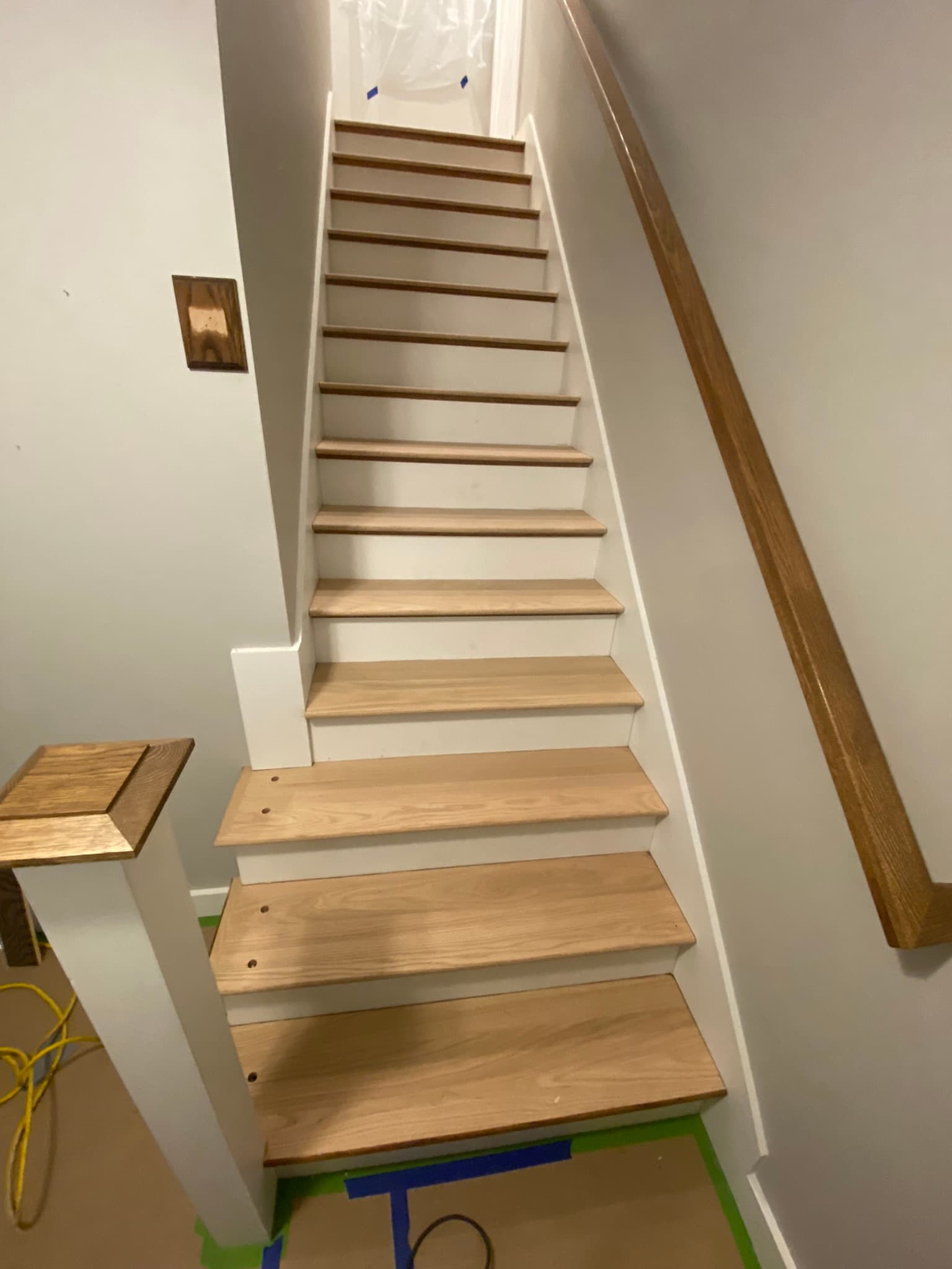 Dark-stained oak stair treads with white risers